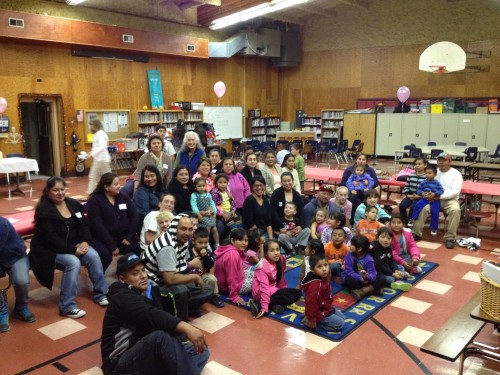 Parents and children at Raising a Reader training