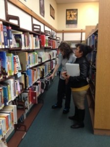 Participants in Abriendo Puertas select books at the Half Moon Bay Library.
