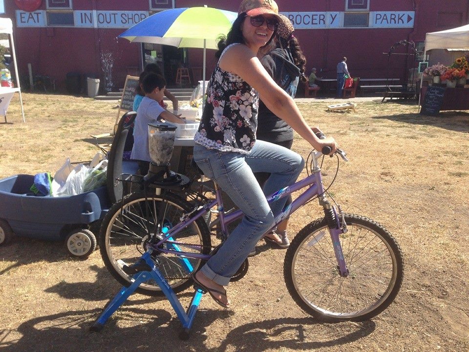 Mona Urbina shows off the blender bike at the market.