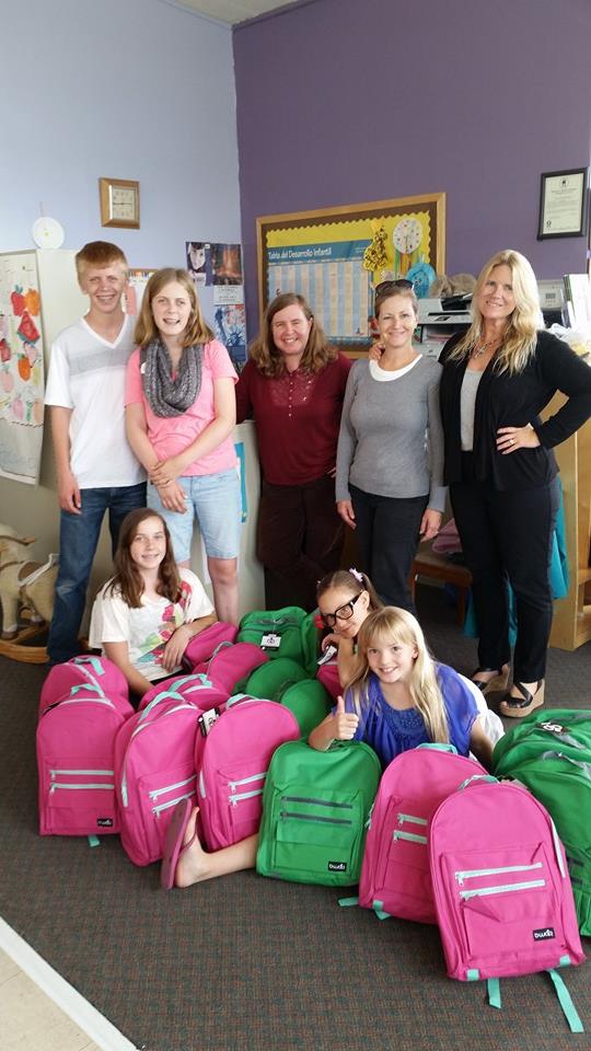 Sarah Thompson (right) with backpacks and members of Benicia Community Congregational Church